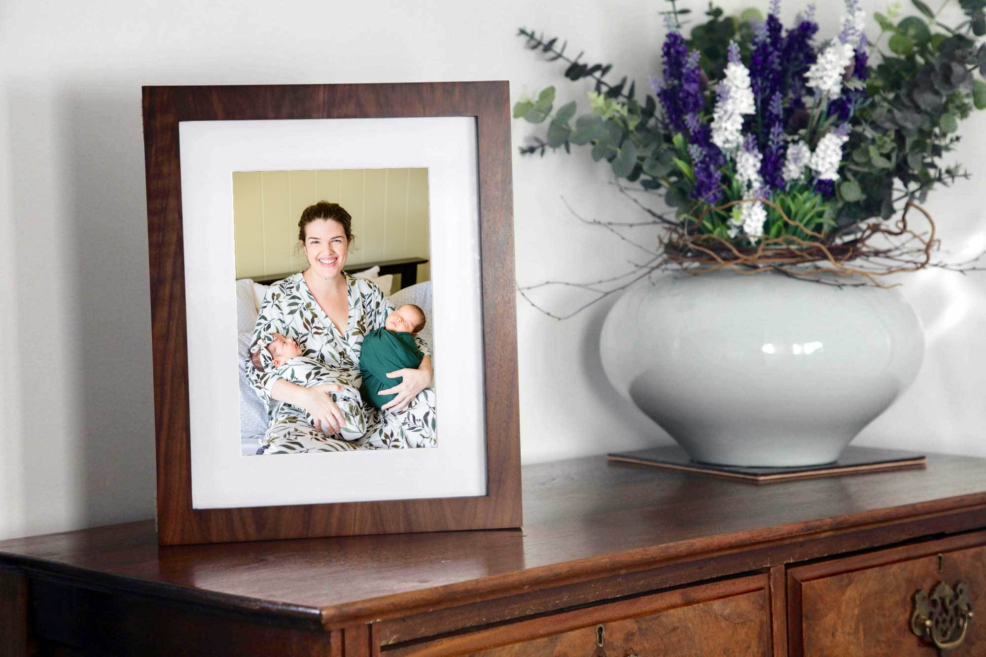 middle georgia newborn photographer. beautiful picture frame of mother with twin newborns